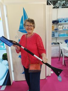 Alison Huth in a red top holding a window cleaner from yautican at Dusseldorf 